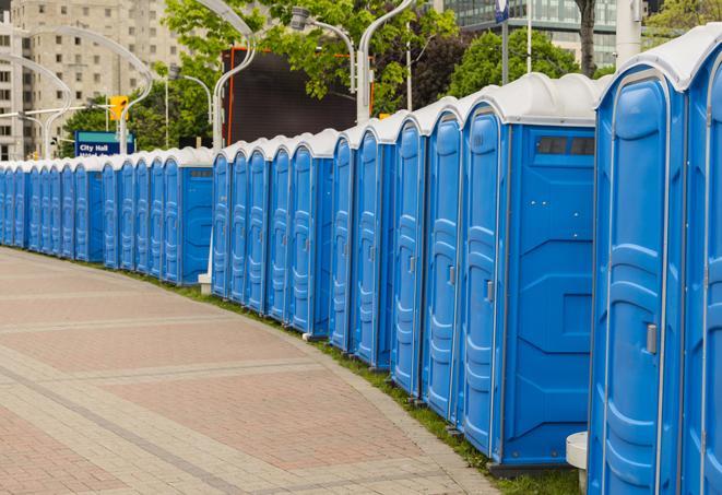 a row of portable restrooms at an outdoor special event, ready for use in Daleville, IN